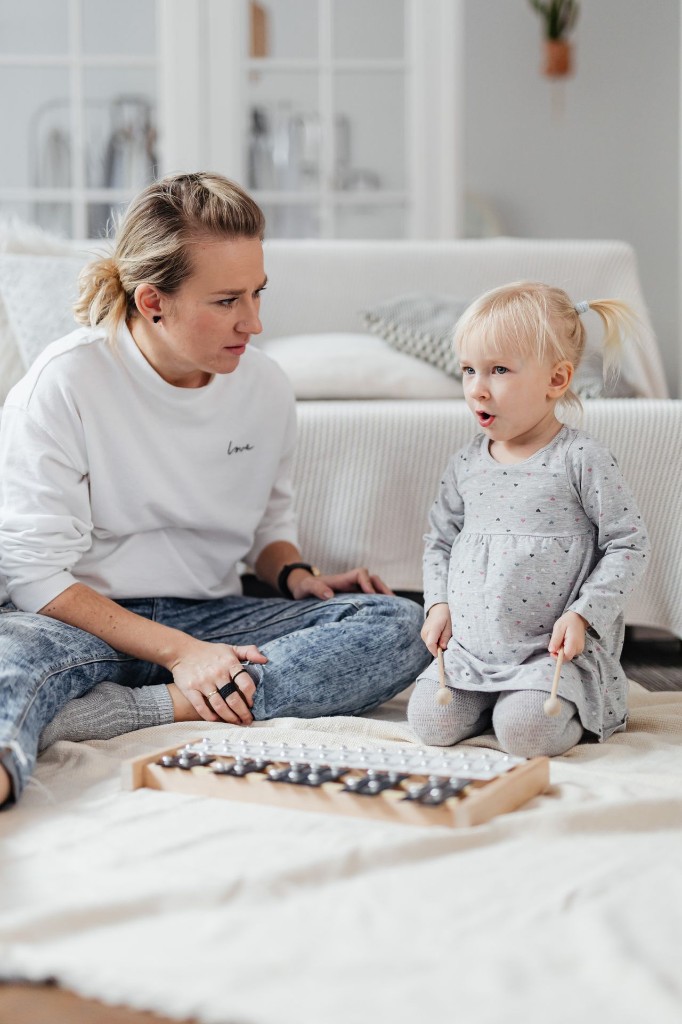 Caregiver and child playing music together